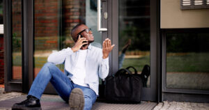 Frustrated African American Man Locked Out of House, Waits for Locksmith