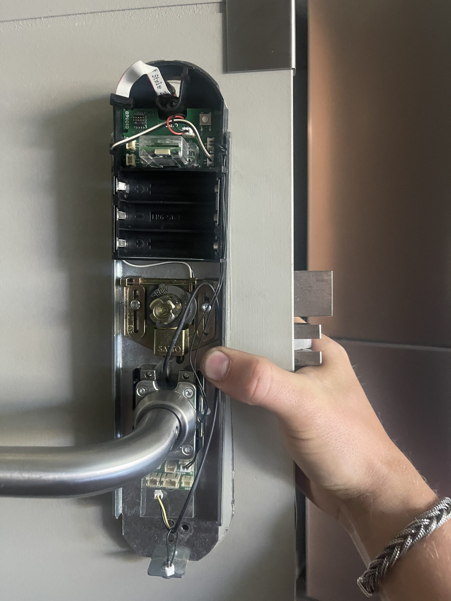 A locksmith installing a deadbolt lock