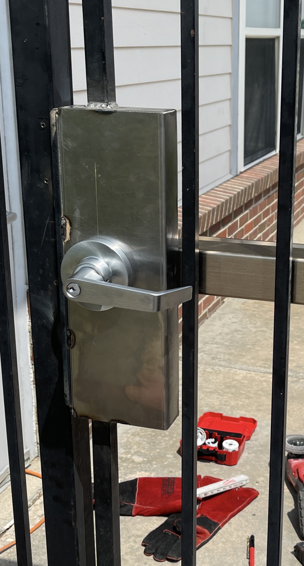 A technician installing a commercial door lock cylinder